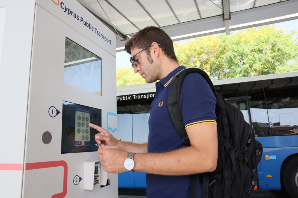 Passenger using a Cyprus Public Transport ticket vending machine